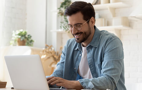 Junger Mann vor dem Laptop